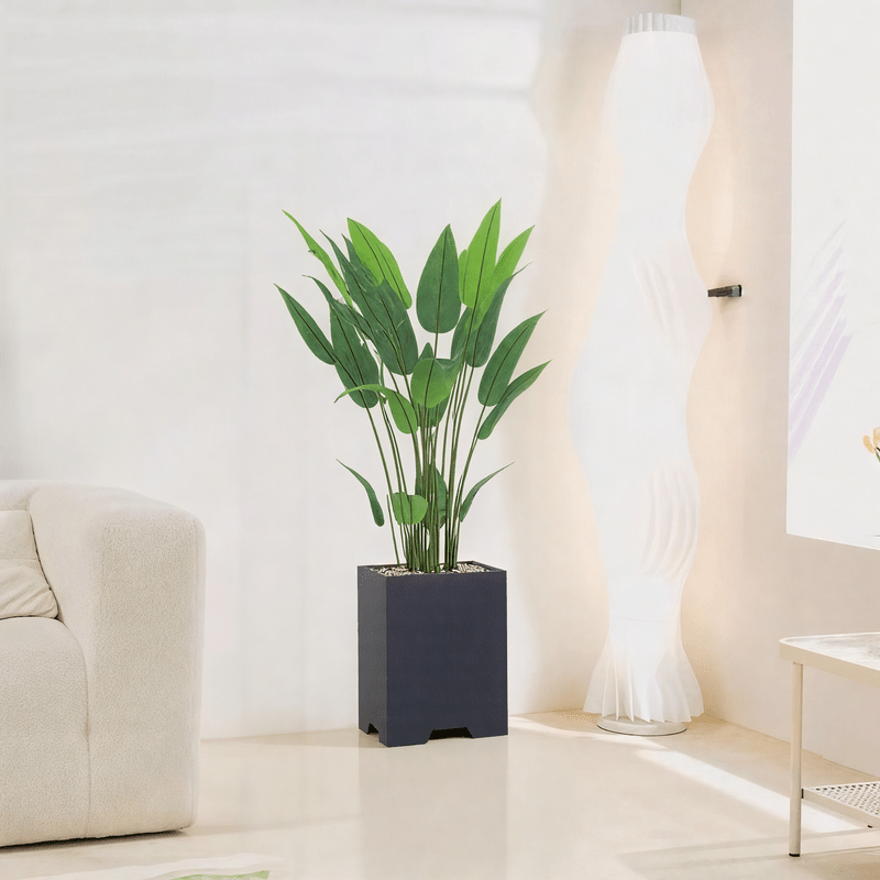 Artificial Bird of Paradise Tree features large green leaves, fiberglass stand, simple and elegant rectangle, available color: black. - Al Rugaib Furniture