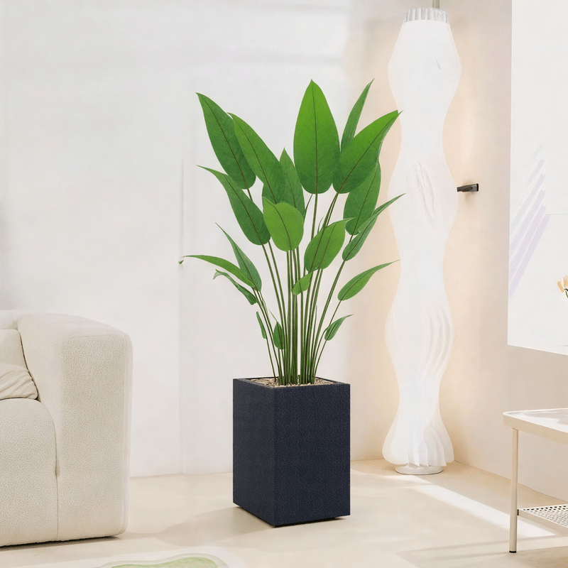 Artificial Bird of Paradise Tree features large green leaves, fiberglass stand, simple and elegant rectangle, available color: black spray. - Al Rugaib Furniture