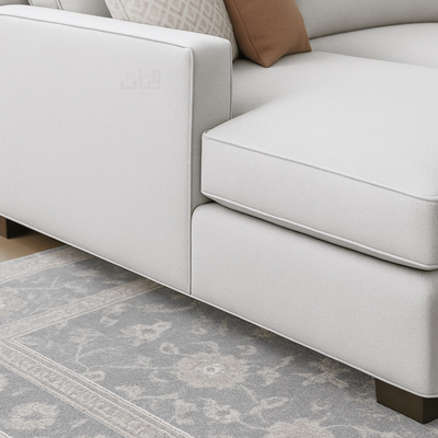 Isla- Sectional Sofa in two corners with a brown cabinet.