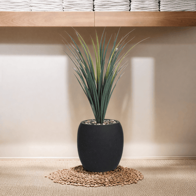 Yucca cactus tree with a fiberglass oval base consisting of a single branch, designed with green leaves that add a lively touch. Available colors: black spray. - Al Rugaib Furniture